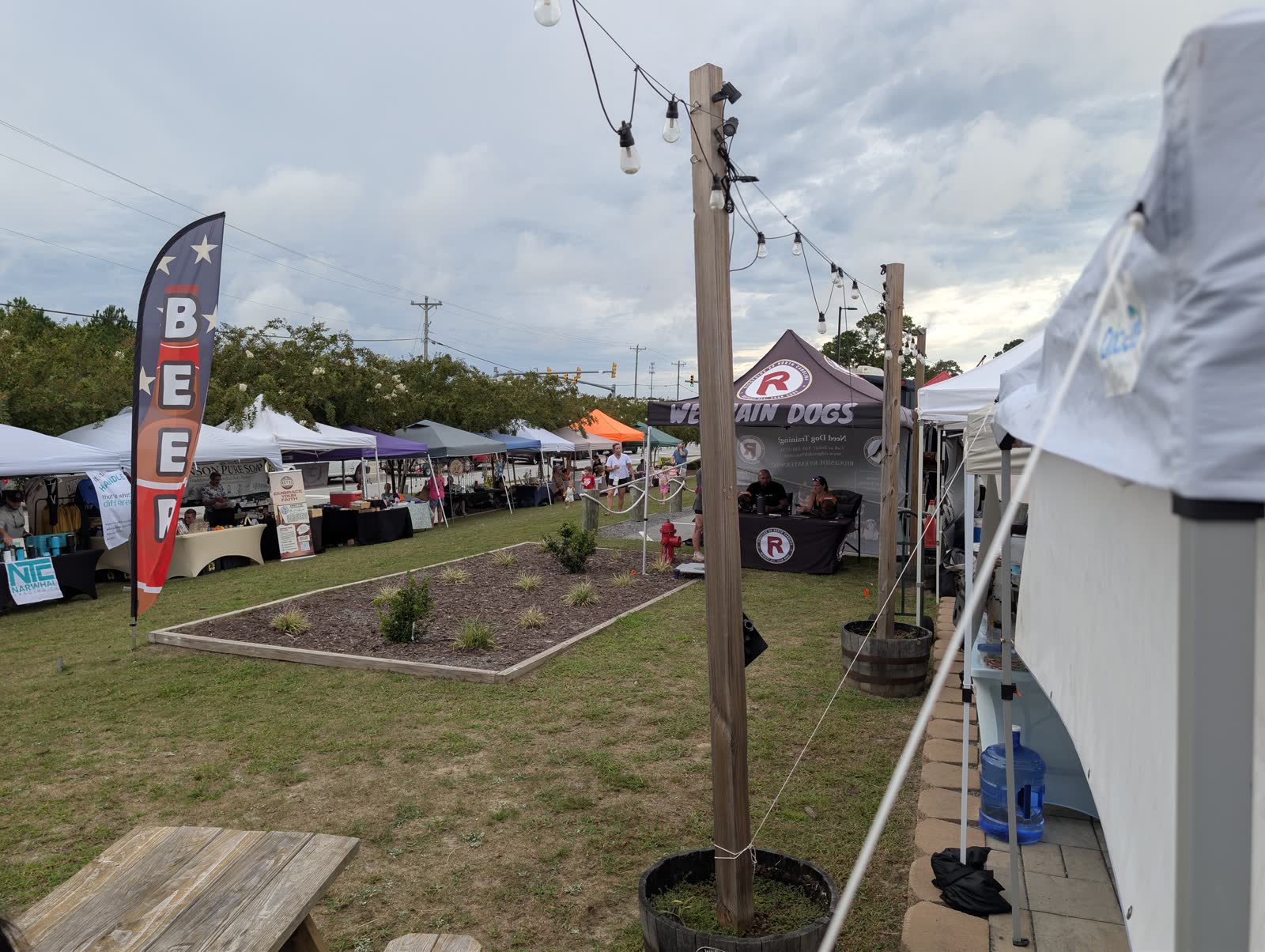 Rows of market tents beside Surf City Brewing Company