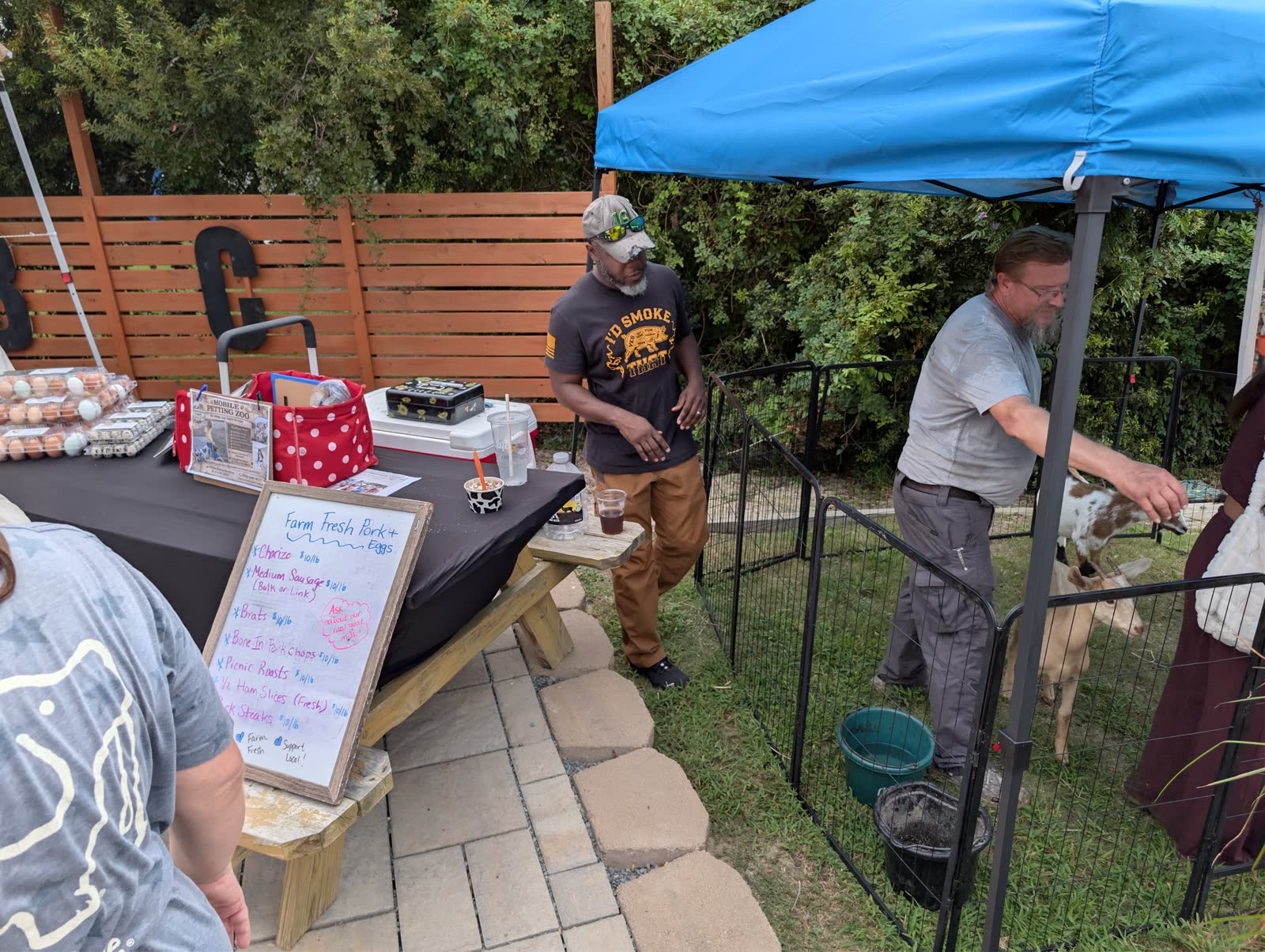 People at a local market booth